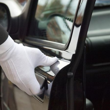 Makati Diamond Residences Makati City Exterior photo A chauffeur opening a car door