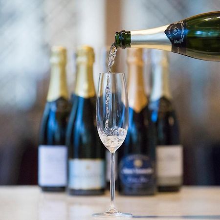 Makati Diamond Residences Makati City Exterior photo Sparkling wine being poured